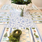 Decorative table setting with a floral centerpiece and bunny placemats.